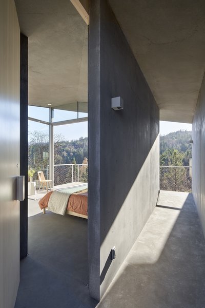 Sunlight pours through glass walls and washes over the interior's smooth, poured-in-place concrete walls, floors, and ceiling.