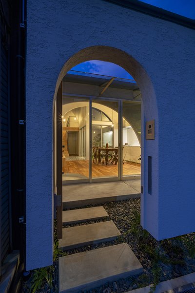 The front door opens to a courtyard. A sliding glass door leads to an open-plan kitchen/dining area.