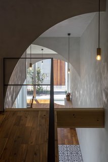 The home's numerous arches lend poetry, geometry, and a dynamic quality to the home as their soft curves frame various perspectives and provide a feeling of airiness.