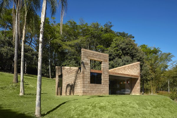 Architect Gustavo Penna designed a 484-square-foot sustainable home in Brazil using glass and blocks made from mining waste and concrete.