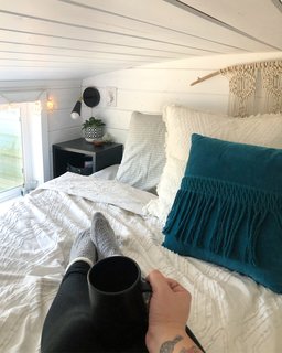 The loft-style bedroom is large enough to accommodate a king-size bed. "I love doing fiber art," Shaffer says. "I made all of the macrame and tassle pieces."