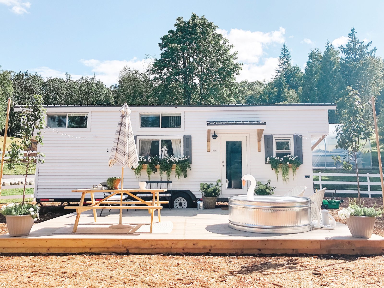 Exterior, Metal Roof Material, Wood Siding Material, House Building Type, and Gable RoofLine Emma McAllan-Braun and her family of four live from her farmhouse-style tiny home on her parents’ property in British Columbia. Ample outdoors space is a boon when living tiny with young children, but with a compostable toilet, and limited areas to entertain, having family or friends over for gatherings. Photo 5 of 9 in Here’s What They Don’t Tell You About Living in a Tiny House from A Canadian Family Thrives in a Charming, Farmhouse-Style Tiny Home