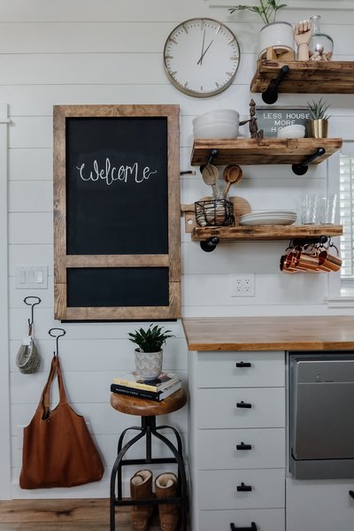 The Perezes Light and Bright Tiny Home Is Born Out of a Love for Adventure 5 a wood framed chalkboard folds down from a wall in the kitchen and provides more counter space and a dining area the open wood shelving was crafted from a beloved table that did not fit in the tiny home