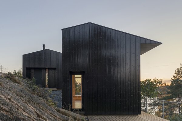The 750-square-foot cabin that architect Jon Danielsen Aarhus designed in Son, Norway, is situated on a sloping hillside of solid rock that overlooks the sea.