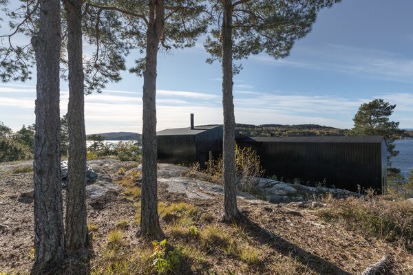 The eastern facade is tucked against the bedrock, allowing for privacy from neighboring homes.

