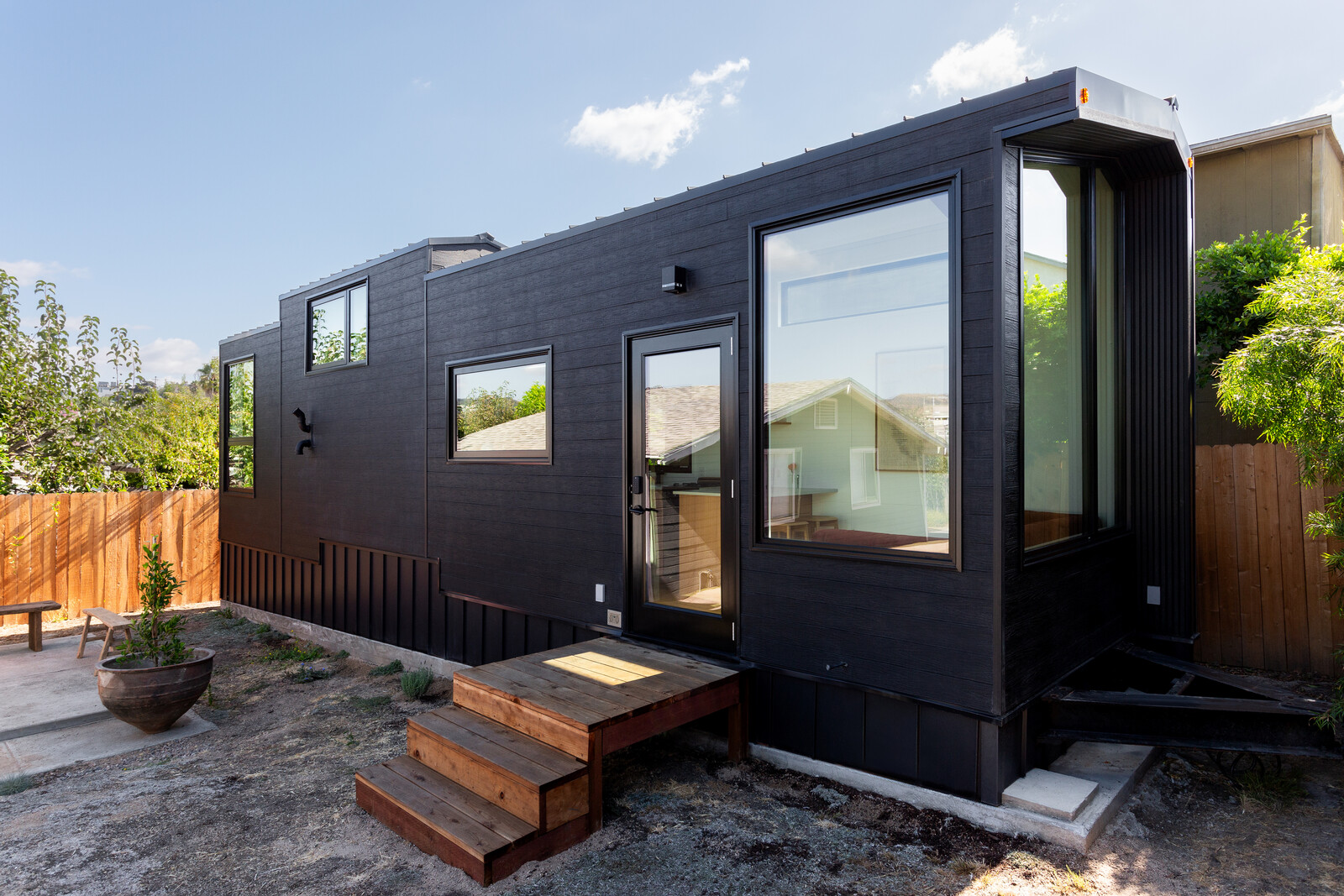 The tiny house, clad in black composite wood by NewTechWood, is situated at the rear of the property. "There are truly beautiful views,