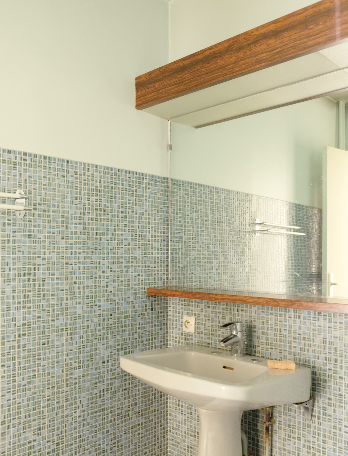Blue and green mosaic tile gave a dated feel in one of the bathrooms.