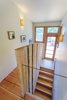 Live-edge oak harvested on site was used as both structure and guardrail at the central stair to the bedroom wing.
Photo 7 of Healdsburg Family House modern home
