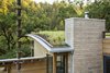 The highly visible living room roof is planted with sedums, blending into the landscape - other roofs are topped by gently curving corrugated metal. Photo 5 of Healdsburg Family House modern home