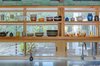 The kitchen transparently links the bars of living space and bedrooms - glass-backed open shelving keeps the space bright. Photo 3 of Healdsburg Family House modern home