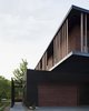 Details like vertically oriented wood siding, straight-forward forms, and overhanging masses were motivated by this modernist aesthetic.
#exterior #bauhaus #wood #kansascity #baulinderhaus #hufft
Photo credit by Mike Sinclair
Photo 4 of BauLinder Haus modern home