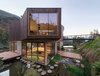 Modern home with Outdoor, Back Yard, Garden, Grass, Gardens, and Walkways. Featuring over 3,000 square feet of living space, Casa El Maqui is comprised of two box-like bases topped with an overhanging timber-clad structure. Photo 5 of A Sustainable Mountain Home in Chile Asks $1.36M