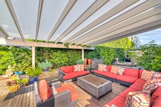 The interiors of the 3,200-square-foot main house have been decked out with attention to high-quality construction and first-rate architectural details. The open cook's kitchen features a built-in dining area and breezy outdoor access. 