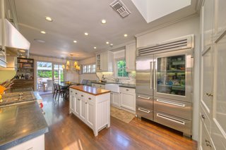 The interiors of the 3,200-square-foot main house have been decked out with attention to high-quality construction and first-rate architectural details. The open cook's kitchen features a built-in dining area and breezy outdoor access. 