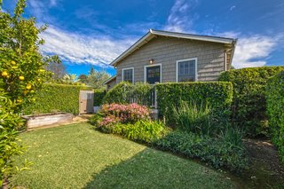 The front of the property has a self-contained, legally-permitted 825-square-foot one-bedroom, one-bath guesthouse with a living room, full kitchen, and private entry. It even has its own landscaped front yard.