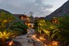 Modern home with Outdoor, Side Yard, Trees, Walkways, and Landscape Lighting. Each of the smaller pavilions is nestled in the landscape of native vegetation and set along a path connected by stepping stones made of cut tree trunks. Photo 2 of Casa en el Pacifico