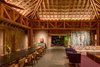 Modern home with Chair, Ceiling Lighting, Table, Cement Tile Floor, Living Room, Sofa, and Coffee Tables. Set close to the sea, this common area is the heart of the complex and is bigger than the other pavilions, featuring 33-foot high ceilings. Photo 4 of Casa en el Pacifico