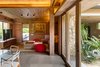 Modern home with Living Room, Sofa, Coffee Tables, Ceiling Lighting, Cement Tile Floor, and Chair. The material palette includes naturally finished local parota wood and rough-cut stone. Photo 11 of Casa en el Pacifico