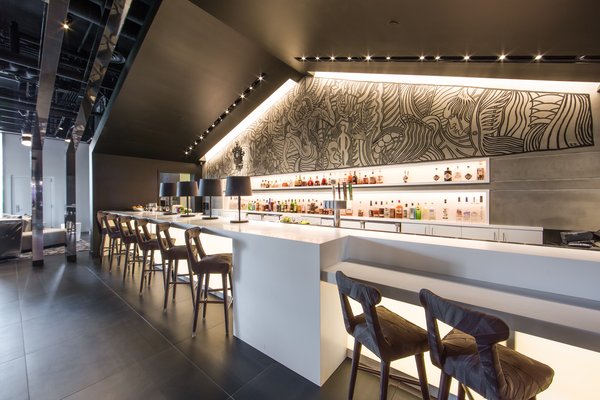 Another large-scale mural is featured behind the hotel bar.