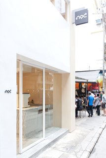 The minimalist facade of Noc Coffee Co. on Gough Street sets it apart from the busy, urban street scene. 