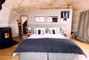 Modern home with Bedroom, Medium Hardwood Floor, Bed, Night Stands, and Table Lighting. Whitepod currently offers 15 pods in 3 different configurations. Photo 5 of Whitepod Eco-Luxury Hotel