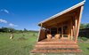 Modern home with Exterior, Cabin Building Type, Wood Siding Material, and Glass Siding Material. Each cabin is spacious enough to accommodate six guests with two bedrooms, a fully equipped kitchen, dining and lounge area, and a covered outdoor terraces. The banks of windows on either side of the huts illuminate the interiors and allow for natural cross ventilation. Photo 3 of Morerava Cabins