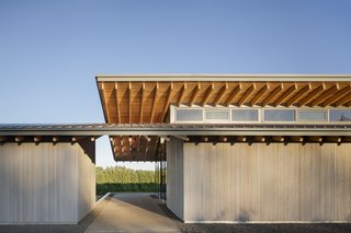 Inspired by the canopied, native oak trees that populate the valley, two cantilevered roof structures interlock at the tasting room's entryway. The material palette is limited to Douglas fir, cedar siding, and dark anodized aluminum.