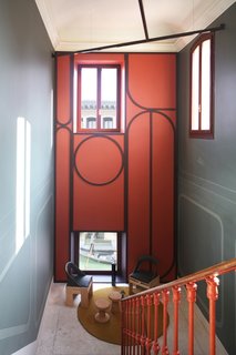 The "inhabited" landing foreshadows the intimacy of the apartment. 