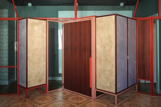 A metal-and-glass partition is set on the original wooden parquet and fitted with doors and cabinets, all designed by Marcante-Testa and built by Materia Design and Om Project.