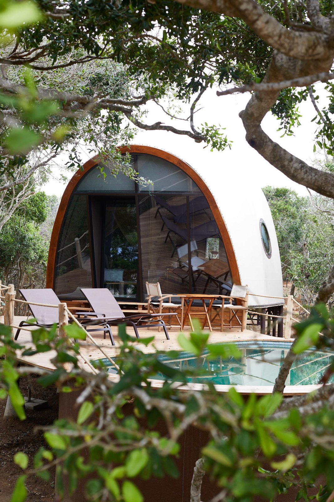 The resort is made up of 28 air-conditioned and tented "cocoon suites." The light-colored domed structures boast soaring vaulted ceilings and offer panoramic jungle views from their double-height glass facades.