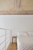 Modern home with Bedroom, Night Stands, Medium Hardwood Floor, and Bed. Original ceiling frescos were left and the walls were painted white. Photo 3 of Numeroventi