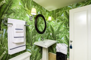 Fernando Wong’s master bath brings the outdoors in with bold wallpaper from the Beverly Hills Collection by Meg Braff Designs.