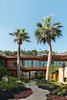 Modern home with Outdoor, Garden, Walkways, Gardens, Trees, Shrubs, Landscape Lighting, Boulders, and Grass. Each features its own custom teak soaking tubs placed under illuminating skylights. Balancing touches like sand-colored, full-height limestone walls evoke a California spirit. Photo 2 of Nobu Ryokan Malibu