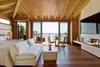 Modern home with Living Room, Medium Hardwood Floor, Chair, Coffee Tables, Lamps, Ceiling Lighting, Sofa, Table, Table Lighting, Ribbon Fireplace, and Gas Burning Fireplace. "There is a moment when the sun enters through the bathroom skylight when you can feel the stillness and calm settle over you," says Studio PCH founder and principal Severine Tatangelo. "That’s the sensibility we aimed to capture in the rooms, patios, and gardens that really makes Nobu Ryokan a retreat destination." Photo 6 of Nobu Ryokan Malibu