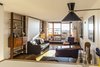 Modern home with Living Room, Floor Lighting, Table, Chair, Ottomans, Shelves, Storage, Sofa, Coffee Tables, Light Hardwood Floor, Wall Lighting, and Lamps. Unité d'Habitation in Marseille, France Photo 12 of Unite d’Habitation