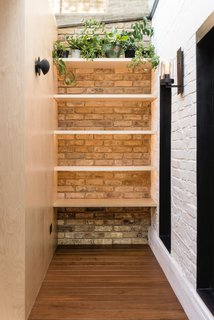 The walls are made of exposed bricks in reference to the original Victorian house.