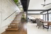 Modern home with Dining Room, Medium Hardwood Floor, Table, Chair, Stools, Travertine Floor, Recessed Lighting, Bar, and Bench. The interiors blend hardwood floors, with concrete and steel. Photo 16 of Joya Villas