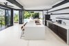 Modern home with Kitchen, Wood Cabinet, Recessed Lighting, Open Cabinet, Refrigerator, Range, and Undermount Sink. Retractable glass doors provide a seamless opportunity for indoor /outdoor living. Photo 8 of Joya Villas