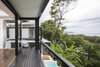 Modern home with Outdoor, Wood Patio, Porch, Deck, Metal Patio, Porch, Deck, and Trees. Unparalleled views of the Costa Rican coast can be enjoyed from the bedroom balcony. Photo 11 of Joya Villas
