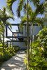Modern home with Exterior, Metal Siding Material, Flat RoofLine, Beach House Building Type, and Wood Siding Material. The approach to Casa Bri Bri. Photo 4 of Joya Villas