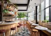 Modern home with Dining Room, Ceramic Tile Floor, Bench, Chair, Stools, Bar, Pendant Lighting, and Table. The light-filled café and bar were envisioned as a social hub for hotel guests as well as the surrounding community.
There's no doubt the teams had their work cut out for them, as the building had been steadily declining since the '70s. Yet, after looking to the building’s storied past and the neighborhood’s current youthful vibe for inspiration, they were able to create a new authentic atmosphere that simultaneously combines historic details with contemporary style. Photo 2 of The Broadview Hotel