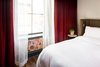 Modern home with Bedroom, Bed, Night Stands, and Dark Hardwood Floor. A detail of the patterned wallpaper in the bedroom, Photo 8 of The Broadview Hotel