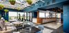 Modern home with Dining Room, Table, Stools, Bar, Pendant Lighting, Chair, and Slate Floor. A glass volume inserted on the roof hosts the lounge and bar. Blue walls and brass pendant lighting in the bar area are juxtaposed against the bright and airy dining area. Photo 9 of The Broadview Hotel