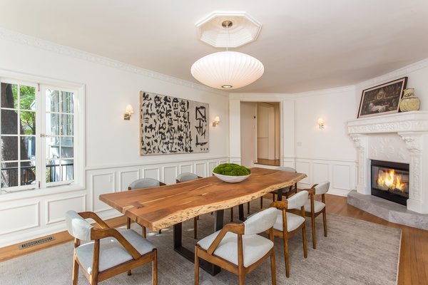 Another intricately detailed wood-burning fireplace graces the dining room.