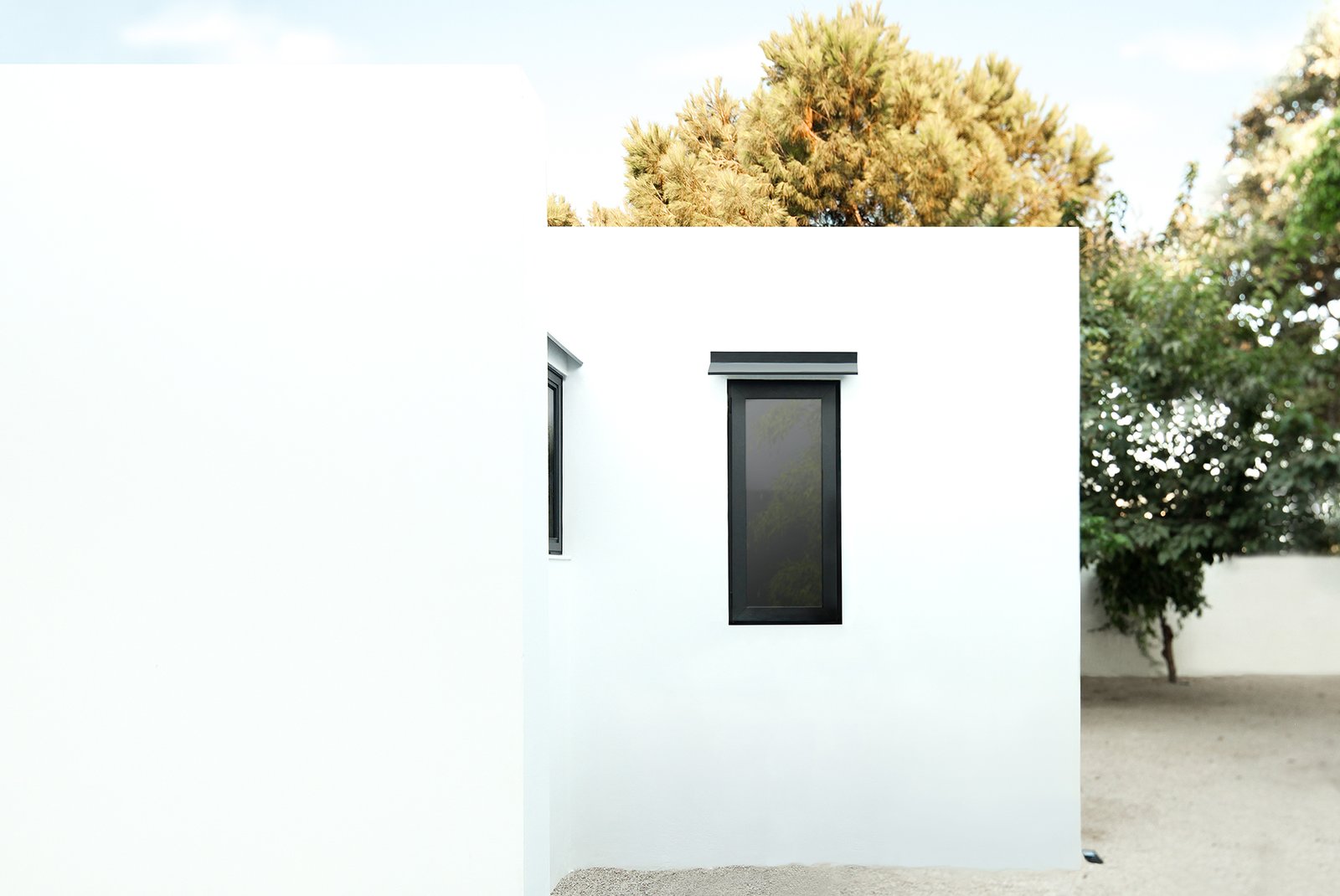 The home's whitewashed exterior references Greek island architecture.