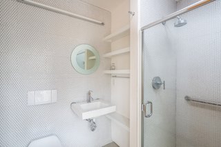 In the guest bathroom, penny tiles have been chosen for their cost-effectiveness.

