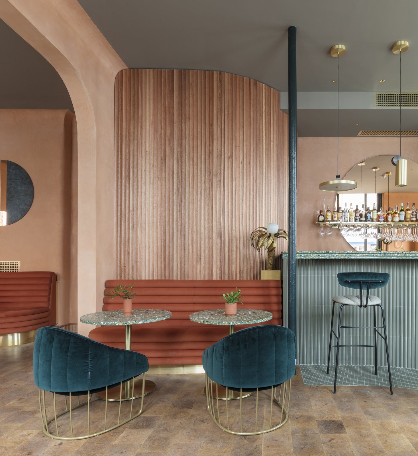 Scalloped Sapele wood slats on the walls add a textural organic element—the tubular design a running motif in the design.