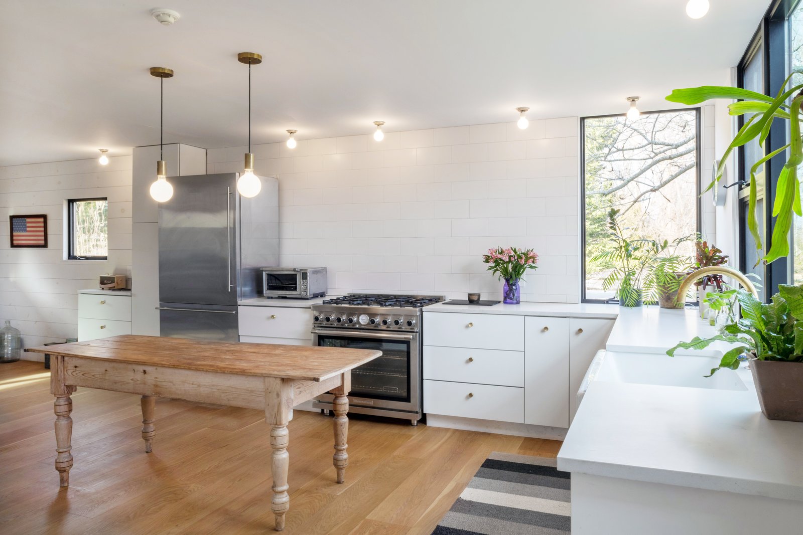 The bright open kitchen has a farmhouse feel.