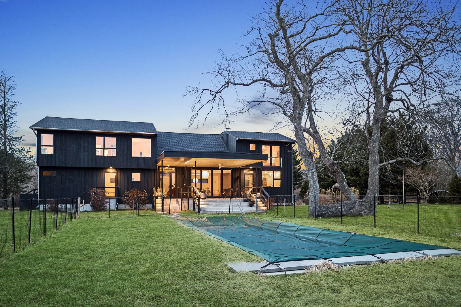 Sliding glass doors lead outside, where there is a heated saltwater pool and patio space for lounging or dining.
