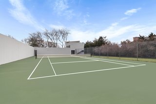 The home is one of only two properties on Bluff Road with a grandfathered-in tennis court on a one-acre lot. 